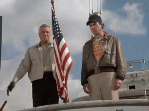 Two Men on Boat With American Flag