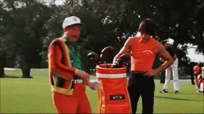 Two Men on Golf Course With Golf Bag