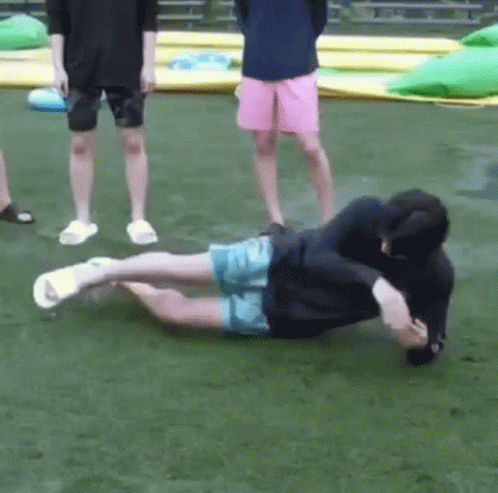 Two Men on Grass, One Lying One Standing