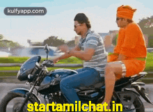 Two Men on Motorcycle One in Orange Turban
