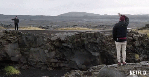 Two Men on Rocky Cliff With Netflix Logo
