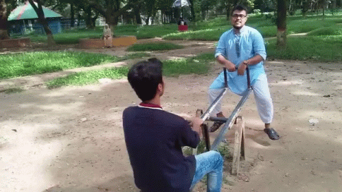 Two Men On Seesaw, One In Blue Shirt GIF