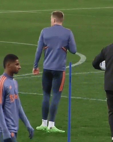 Two Men on Soccer Field One in Blue Adidas