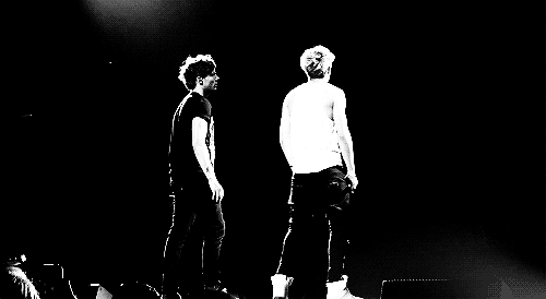 Two Men on Stage With Microphones