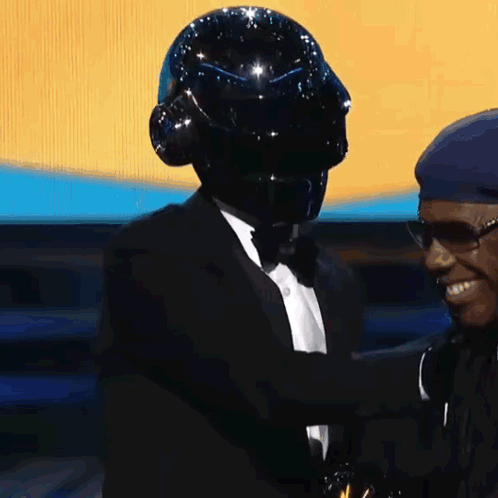 Two Men One in Black Helmet and Tuxedo