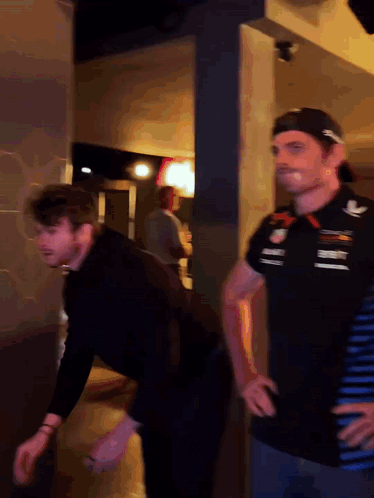 Two Men, One In Red Bull Shirt GIF