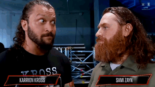 Two Men One Wearing Karrion Kross Shirt