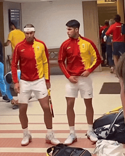 Two Men One Wearing Spain Red and Yellow Shirt