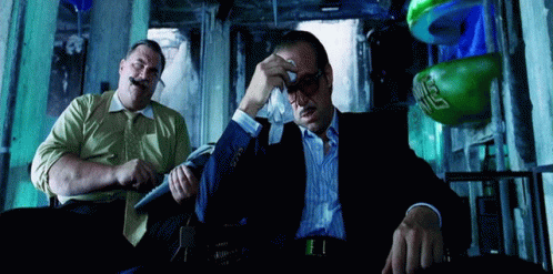 Two Men, One With Green Boxing Glove and Letter S