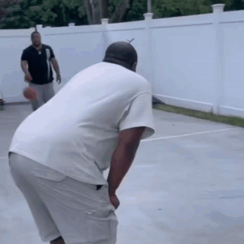 Two Men Playing Basketball on Court