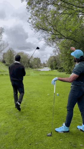 Two Men Playing Golf GIF