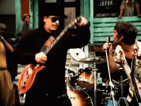 Two Men Playing Guitar and Drums