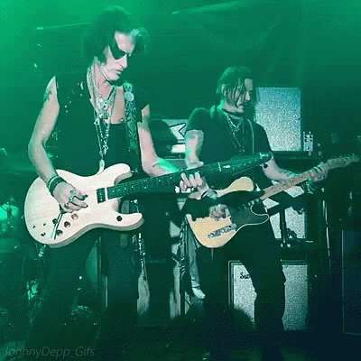 two men playing guitars in front of a green background that says jenny depp gifs on it