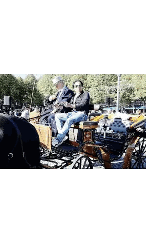 Two Men Riding Horse-Drawn Carriage