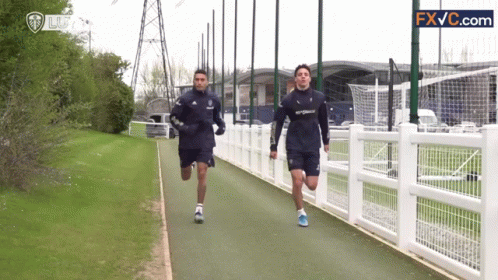 Two Men Running on Path
