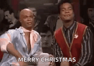 Two Men Saying Merry Christmas In A Bar GIF