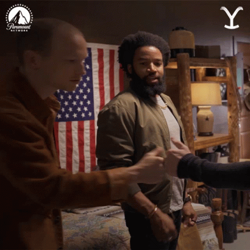 Two Men Shake Hands American Flag Paramount Logo GIF