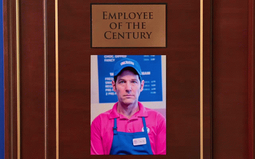 Two Men Shaking Hands in Front of Employee of the Century Plaque