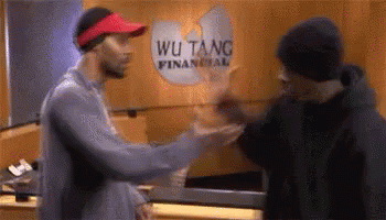Two Men Shaking Hands in Front of Wu Tang Financial Building