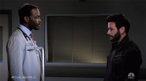 Two Men Shaking Hands With NBC Logo GIF
