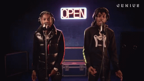 Two Men Sing In Front Of An Open Sign GIF