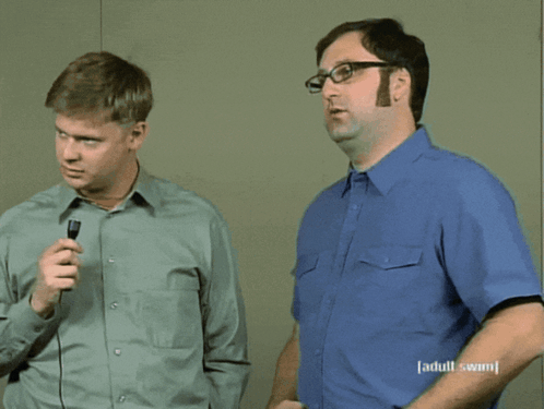 Two Men Singing In Front Of A Microphone With The Words Fair Enough Above Them GIF