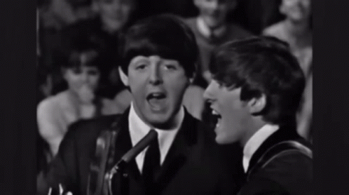 Two Men Singing Into Microphones With Crowd GIF
