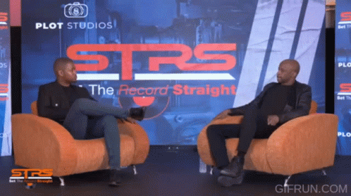 Two Men Sit In Chairs In Front Of A Screen That Says Strs GIF