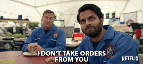 two men sitting at a table with one saying i don 't take orders from you