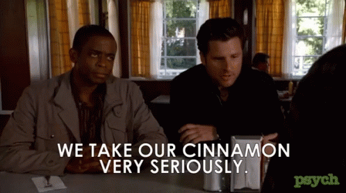 two men sitting at a table with the words we take our cinnamon very seriously