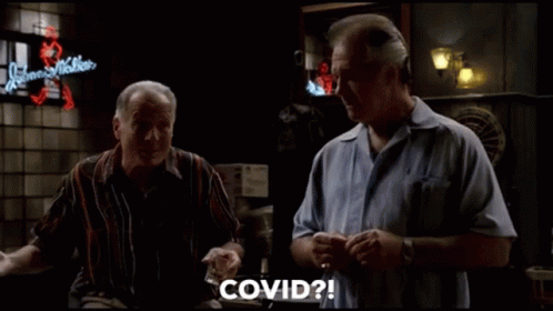 Two Men Sitting At Bar Talking GIF