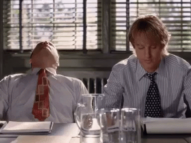 Two Men Sitting at Desk Heads Down