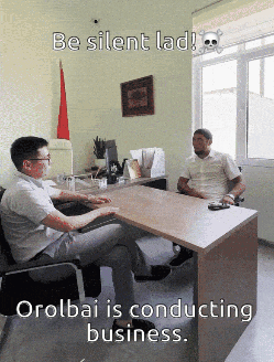 Two Men Sitting At Desk With Skull And Crossbones GIF