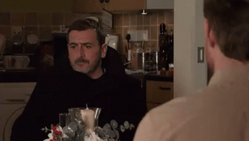Two Men Sitting At Kitchen Table GIF