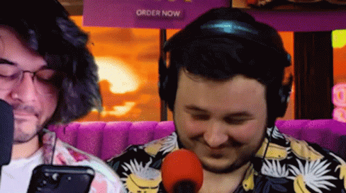 Two Men Sitting At Microphone GIF