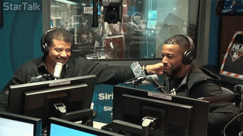 Two Men Sitting At Microphone In Star Talk Studio GIF