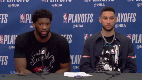 Two Men Sitting at Playoffs Table