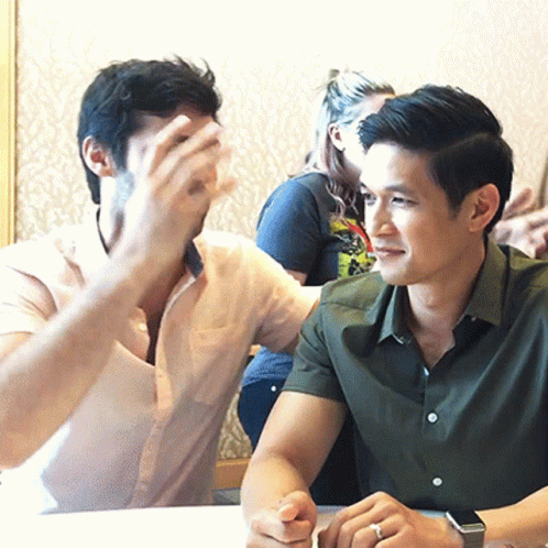 Two Men Sitting at Table, One Wearing Watch