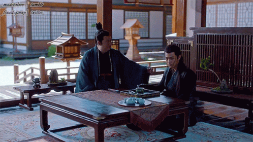 Two Men Sitting at Table
