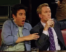 Two Men Sitting at Table with Beer