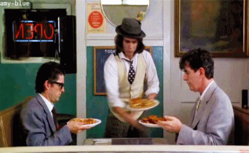 Two Men Sitting at Table with Food