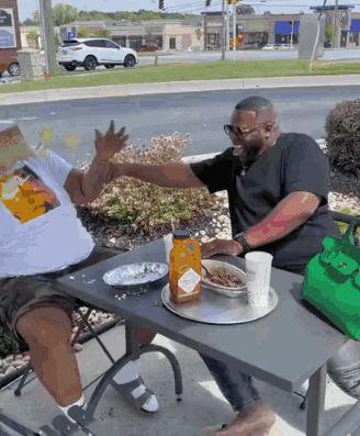 Two Men Sitting at Table With Tabasco Sauce
