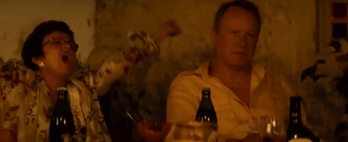 Two Men Sitting at Table With Wine