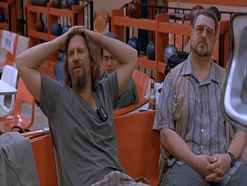 Two Men Sitting in Bowling Alley