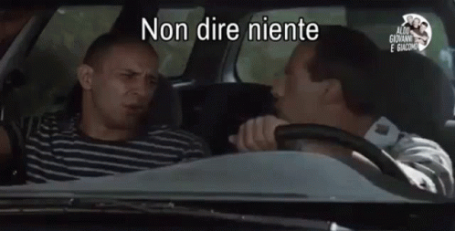 Two Men Sitting in Car Non Dire Niente