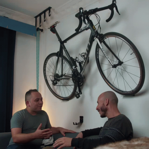Two Men Sitting In Front Of Bicycle With Scott GIF