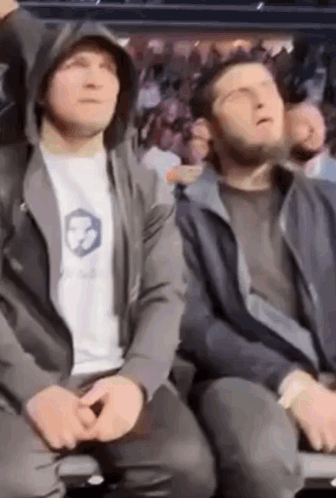 Two Men Sitting In Stadium Watching Boxing Match GIF