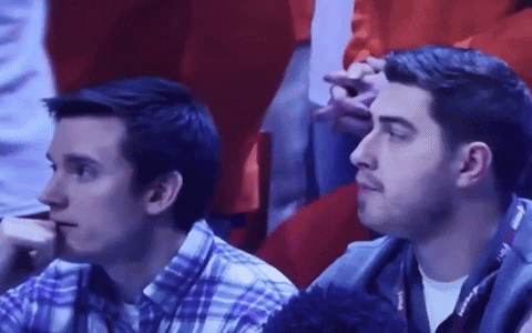 Two Men Sitting in Stadium Watching Game