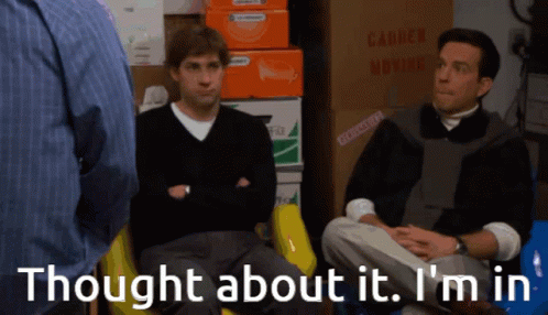 Two Men Sitting Near Moving Boxes And Sign GIF