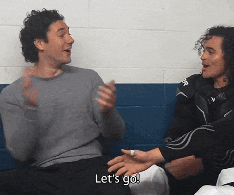 Two Men Sitting Next To Each Other